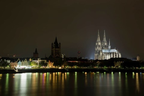 The Cologne Cathedral illuminated at night with Rhine