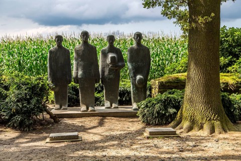 Langemark German war cemetery with monument ""Grieving Soldiers"" by Emil Krieger