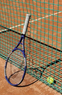 Tennis racket next to net