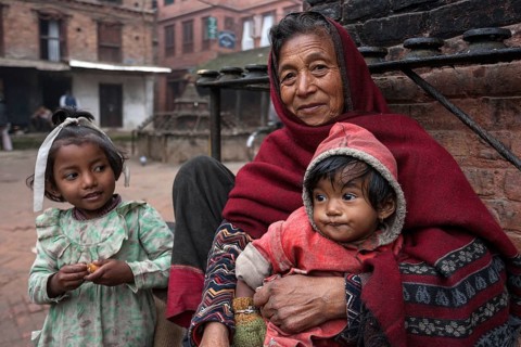Elderly Nepalese woman with two children