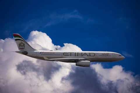 A6-EYK Etihad Airways Airbus A330-243 in flight against a cloudy sky