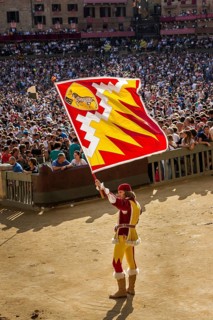 Man carrying a flag from the Ram contrade