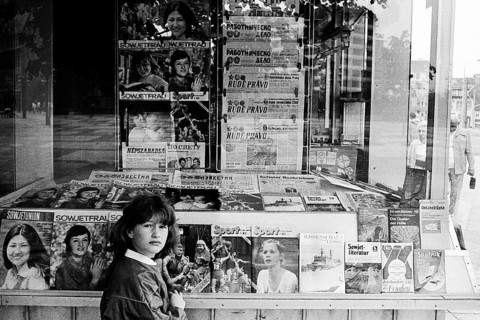 Girl in front of a kiosk of the Post-Zeitung Vertriebes PZV of the GDR in Dunkerstrasse