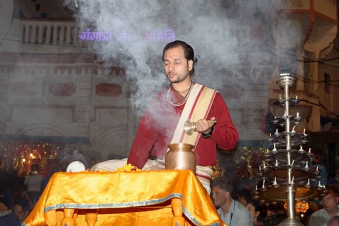 Priest celebrating the Aarti by offering incense