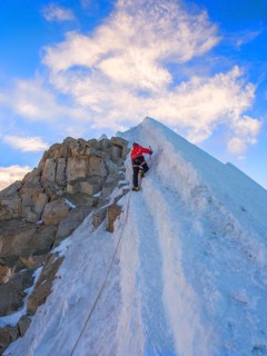 Roped alpinist climbing