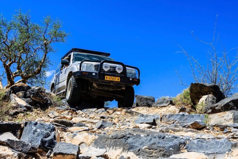 SUV driving down rock steps