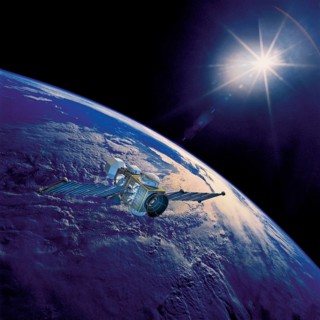 Geostationary orbit satellite above the Earth pointed toward the rising sun