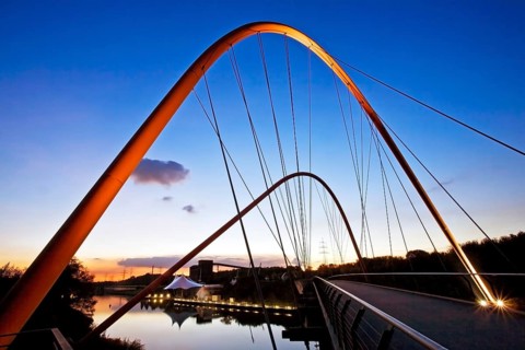 Illuminated double arch bridge over the Rhine-Herne Canal