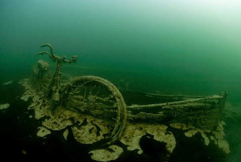 Rowing boat wreck with sunken bike