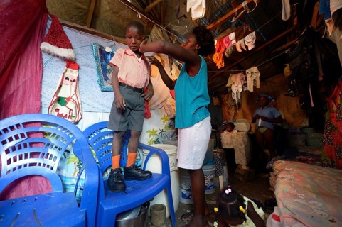 Woman dressing her son