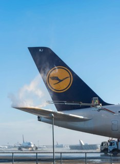 Tail fin of a Lufthansa Airbus A380-841 during deicing at Frankfurt Airport