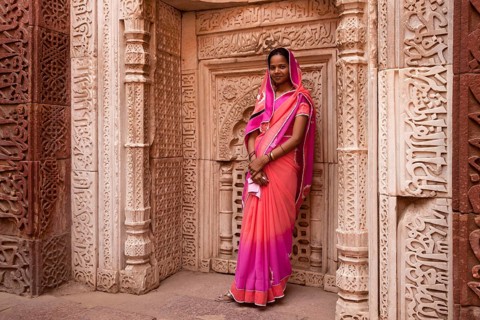 Young Indian woman posing in the Qutub Minar Complex or Qutb Complex