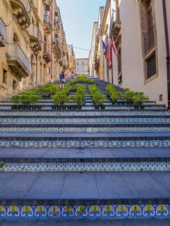 The Santa Maria del Monte staircase with ceramic tiles and potted plants