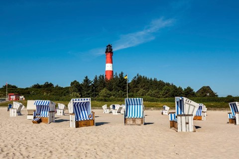 Beach chairs on the beach in front of the lighthouse