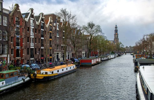 Houseboats on Prinsengracht with Westerkerk tower