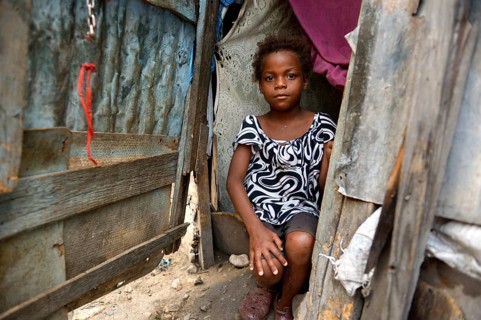 Girl in the entrance of a shack