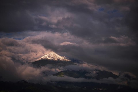 Snow-capped Mt Rosskogel with looming clouds