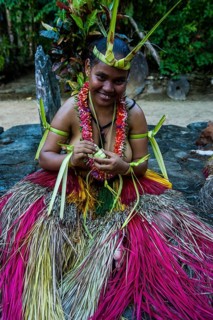 Traditionally dressed islander making traditional art work