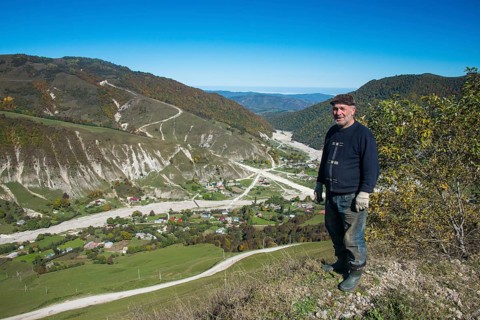 Old Chechen man at an overlook in the Chechen mountains