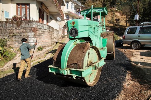 Road construction workers laying tar