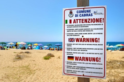 Funny German translation on a warning sign on the beach