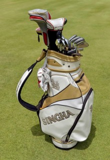 Golf bag with clubs on the green