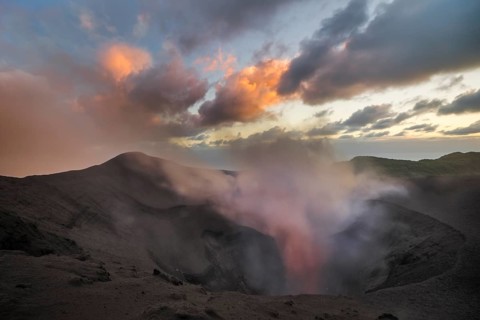 Steam rises from the open crater of the volcano Mount Yasur