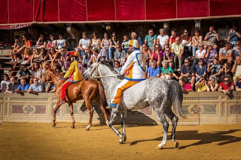 Jockeys waiting for the start of Palio di Siena horse race on Piazza del Campo