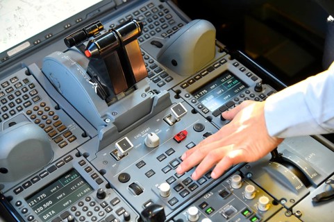 Cockpit with hand on the switch