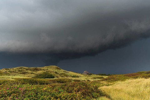 Dramatic storm clouds over dunes