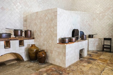 Copper utensils in vintage kitchen with baking stove
