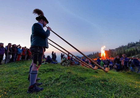 Alphorn players and bonfires