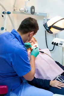 A customer is treated professionally in a dentist's surgery for inexpensive treatment for dentures