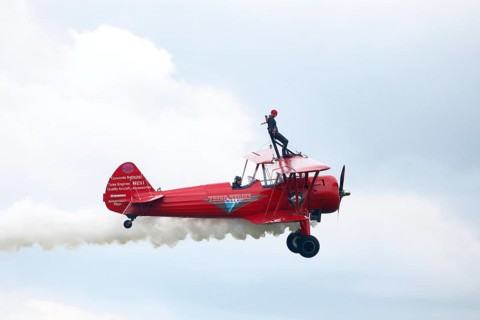 Wing walker on a biplane at an air show