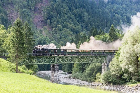 Bregenz Forest Railway with steam locomotive crossing steel bridge