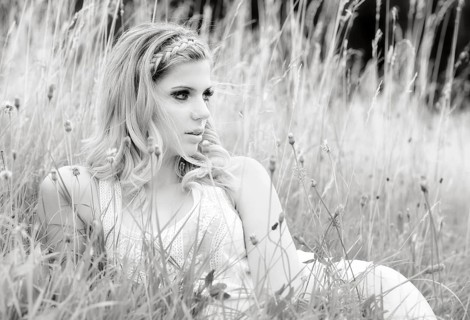 Young woman in lingerie posing outdoors