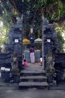 Believers making offerings in a small side temple
