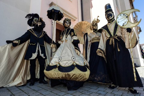 Venetian Carnival masks and costumes at the Venetian Fair on the historic market square