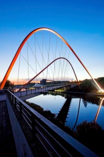 Illuminated double arch bridge over the Rhine-Herne Canal