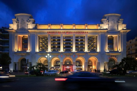 Hotel and Casino Palais de la Mediterranee on the Promenade des Anglais in the evening
