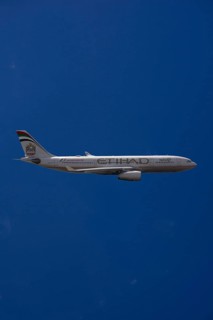 A6-EYK Etihad Airways Airbus A330-243 in flight against a blue sky
