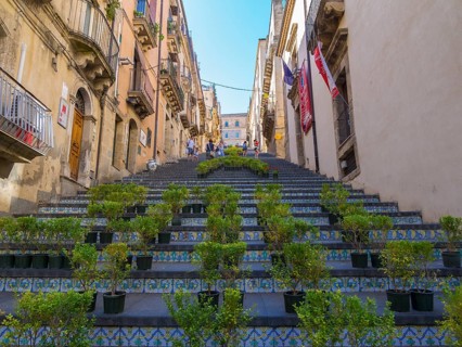 The Santa Maria del Monte staircase with ceramic tiles and potted plants