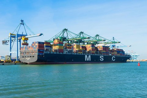 Docked cargo containers being loaded