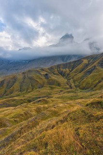 Pelvoux landscape with the Les Aiguilles d'Arves mountain between fog and clouds