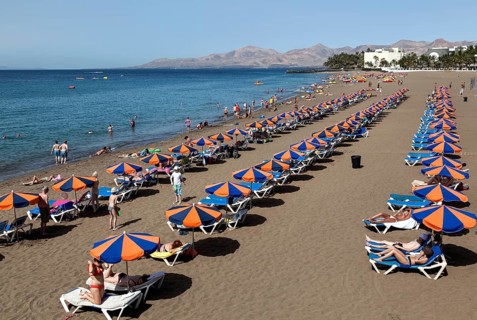 Playa Blanca beach with parasols and sun loungers