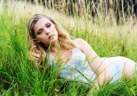 Young woman in lingerie posing outdoors