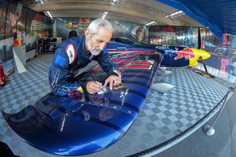 Peter Besenyei posing with his plane before the Red Bull Air Race