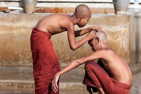 Novice monks during a head shave in the Shwe Yaunghwe Kyaung Monastery