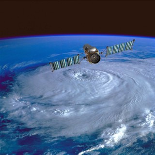 Weather monitoring satellite orbiting over a hurricane