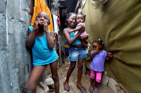 Four children in the entrance of a shack